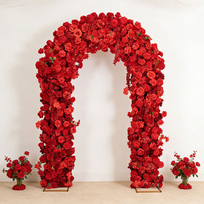 Red rose floral arch with matching bouquets on a white wall background