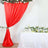 Red draped fabric backdrop with floral accents and a white table arrangement #whtbkgd