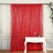 Red shimmering curtain draped elegantly in front of a white table.