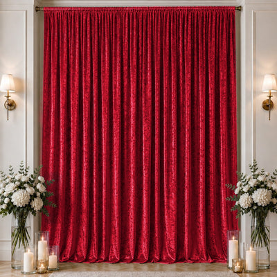 Red velvet stage curtain with floral arrangements and candle decor