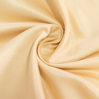 Soft beige satin fabric with a smooth texture and gentle drape. #whtbkgd