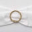 Gold and crystal embellishment on white fabric bow