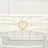 White chair sash with a heart-shaped rhinestone embellishment