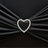 Heart-shaped rhinestone brooch on black fabric.