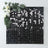 Decorative black and white grid wall art with floral accents.
