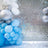 Colorful balloon arrangement with silver and blue accents against a mirrored backdrop.