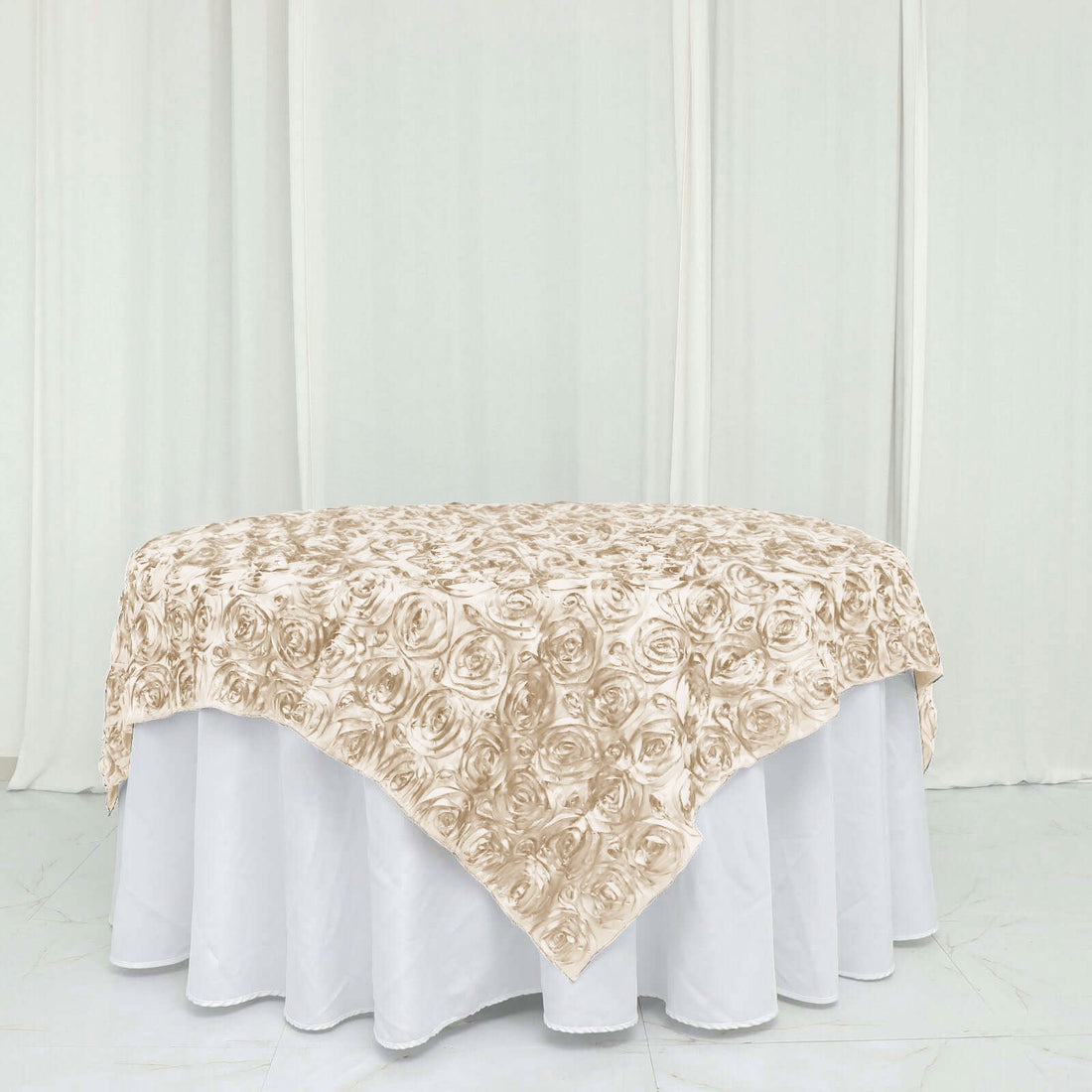 Beige rose-patterned tablecloth on a round table.