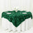 Green rose-patterned tablecloth draped over a round table with floral centerpiece.