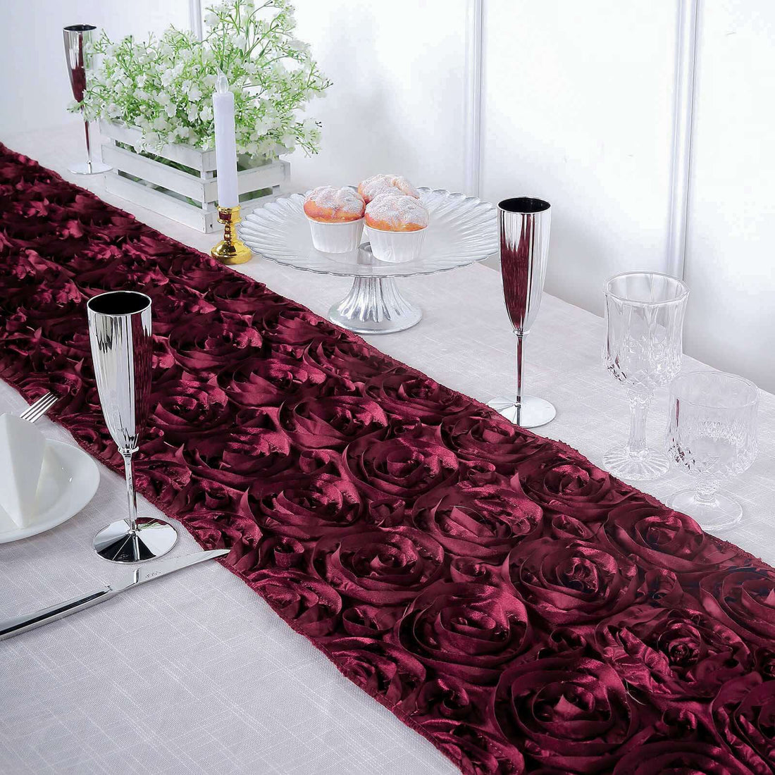 Burgundy rose-patterned table runner on elegantly set dining table