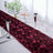 Burgundy rose-patterned table runner on elegantly set dining table