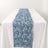 Blue satin rose table runner on a white table.