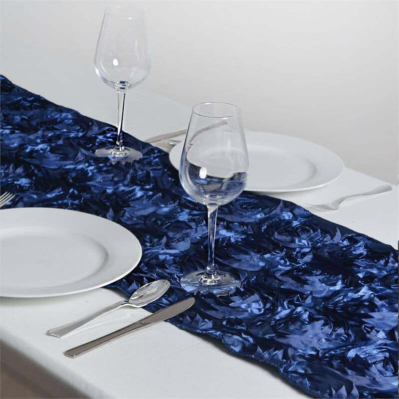 Navy blue decorative table runner with white plates and glassware