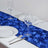 Blue rose-patterned table runner on a dining table with plates and glasses.