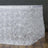 White floral tablecloth with 3D rose design.