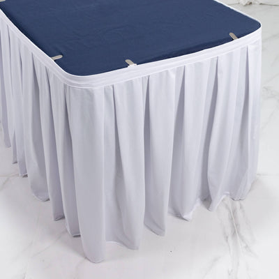 Round banquet table with navy topper and white floor-length table skirt
