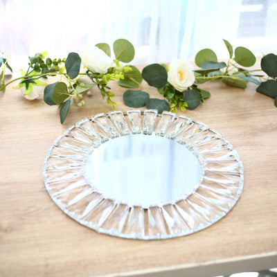 Round crystal decorative mirror on wooden table with floral greenery backdrop