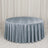 Round table with light blue velvet tablecloth in elegant event setting
