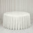 Round white tablecloth on a banquet table in a minimal white room