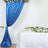 Blue satin backdrop curtain with floral arch and table decor
