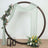 Decorative floral hoop with draped fabric and lanterns, styled for events.