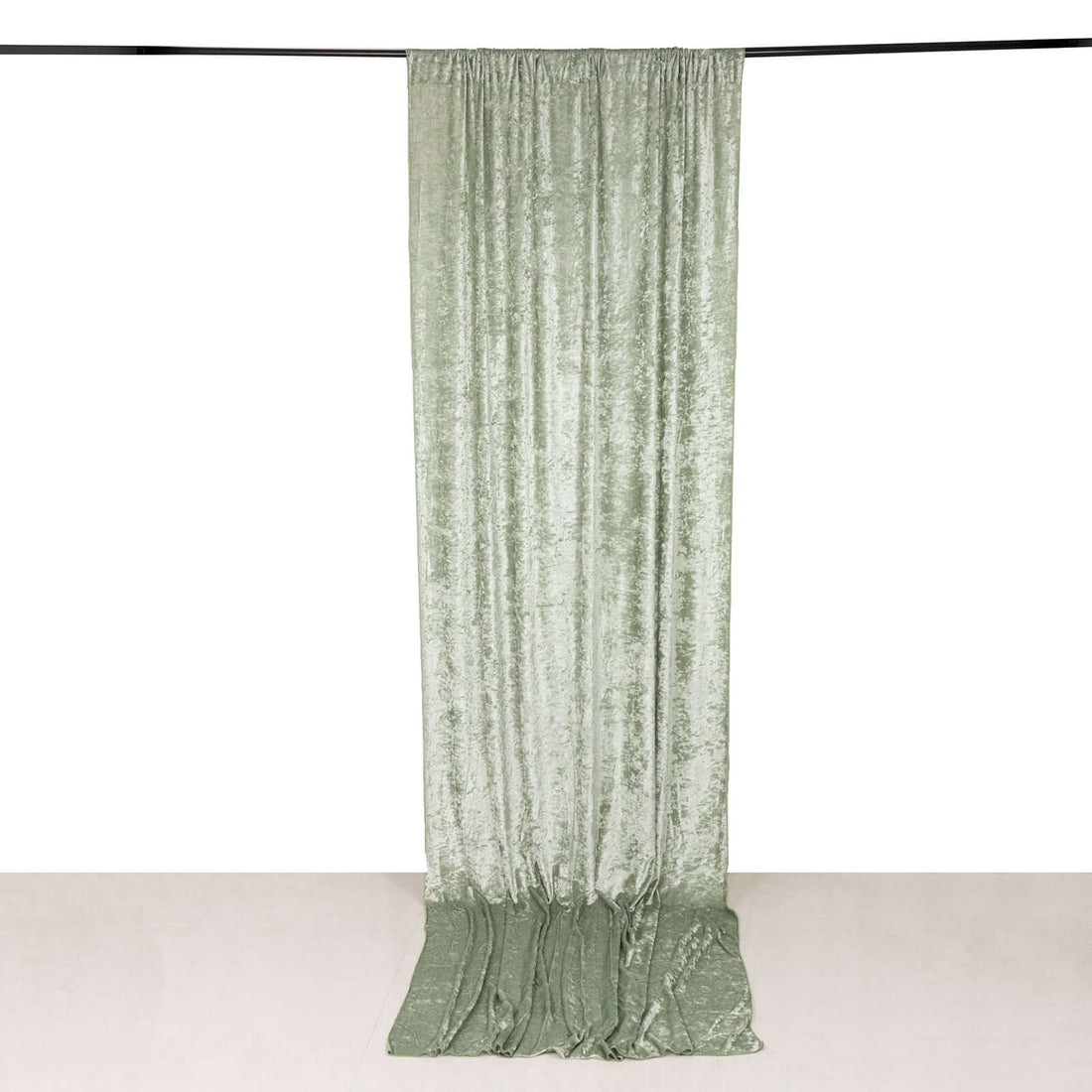 Green velvet curtain draped and hanging in studio-style isolation shot