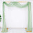 Green sheer fabric draped over a wooden frame on a plain background.