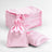 Pink satin drawstring bags stacked with one bag and a pillow on a white background