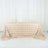 Rose textured table cover in champagne color on a plain backdrop.