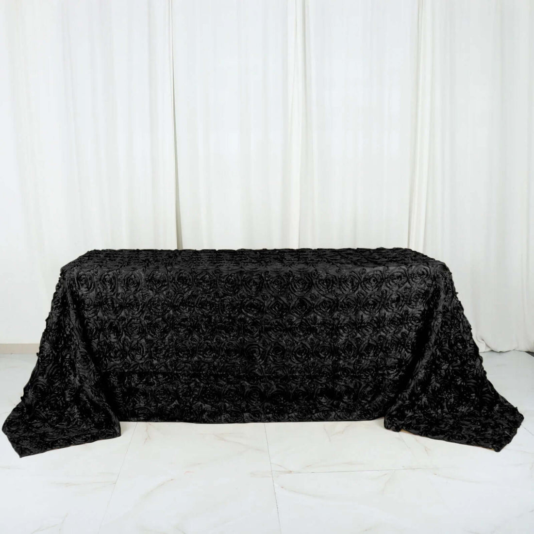 Black floral textured tablecloth on a plain background