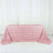 Pink rose-patterned tablecloth on a white backdrop.