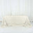 Textured rose-pattern tablecloth in soft cream color.