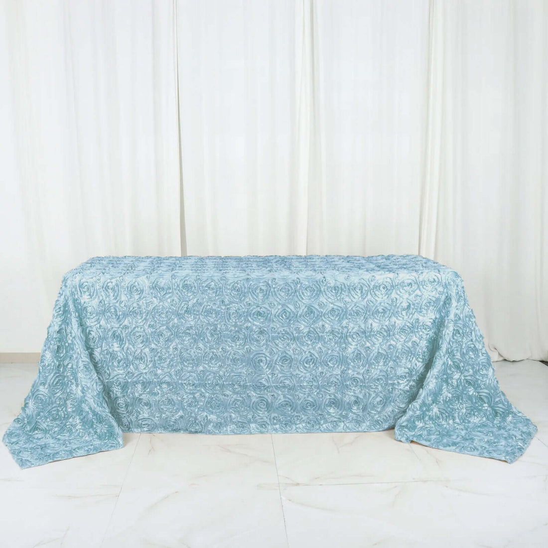 Blue textured tablecloth draped elegantly over a table.