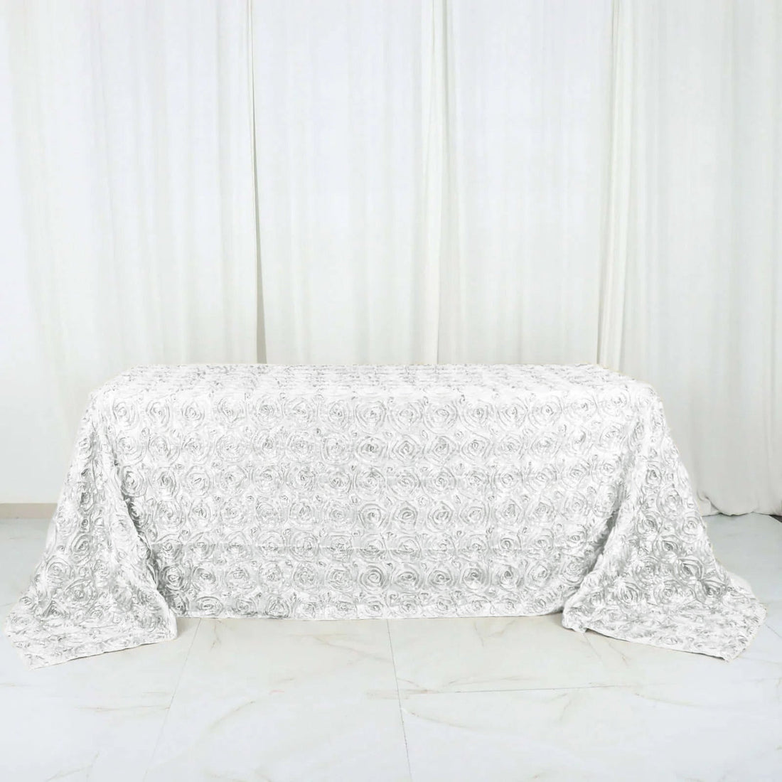 White floral textured table cover on a plain background