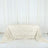 Textured cream tablecloth with floral design on a table.