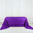 Purple rose-patterned tablecloth draped over a table.