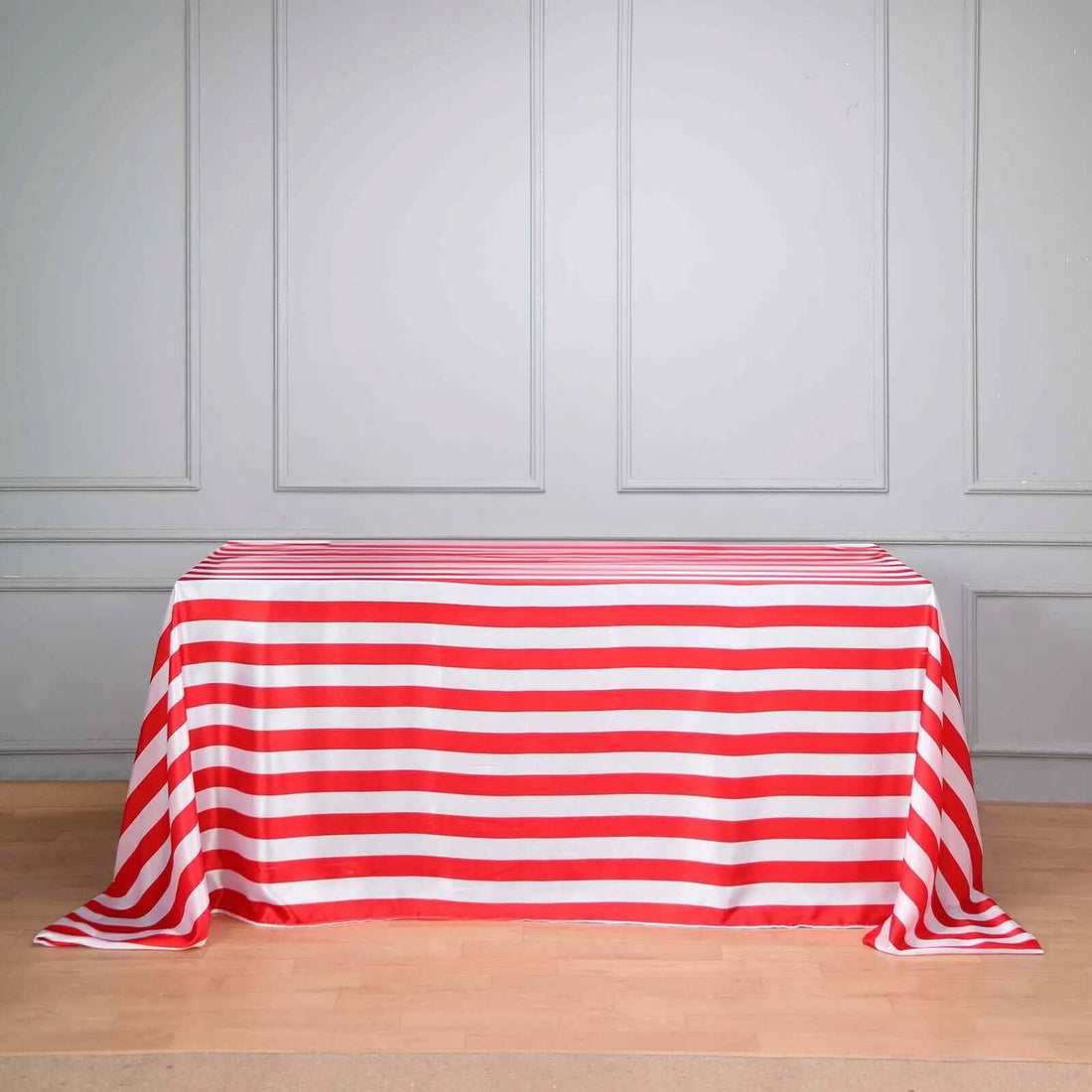 Red and white striped tablecloth on a wooden floor.