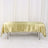 Gold satin tablecloth draped over a table against a plain backdrop