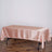 Pink satin tablecloth draped over a rectangular table.