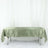 Green satin tablecloth draped over a table.