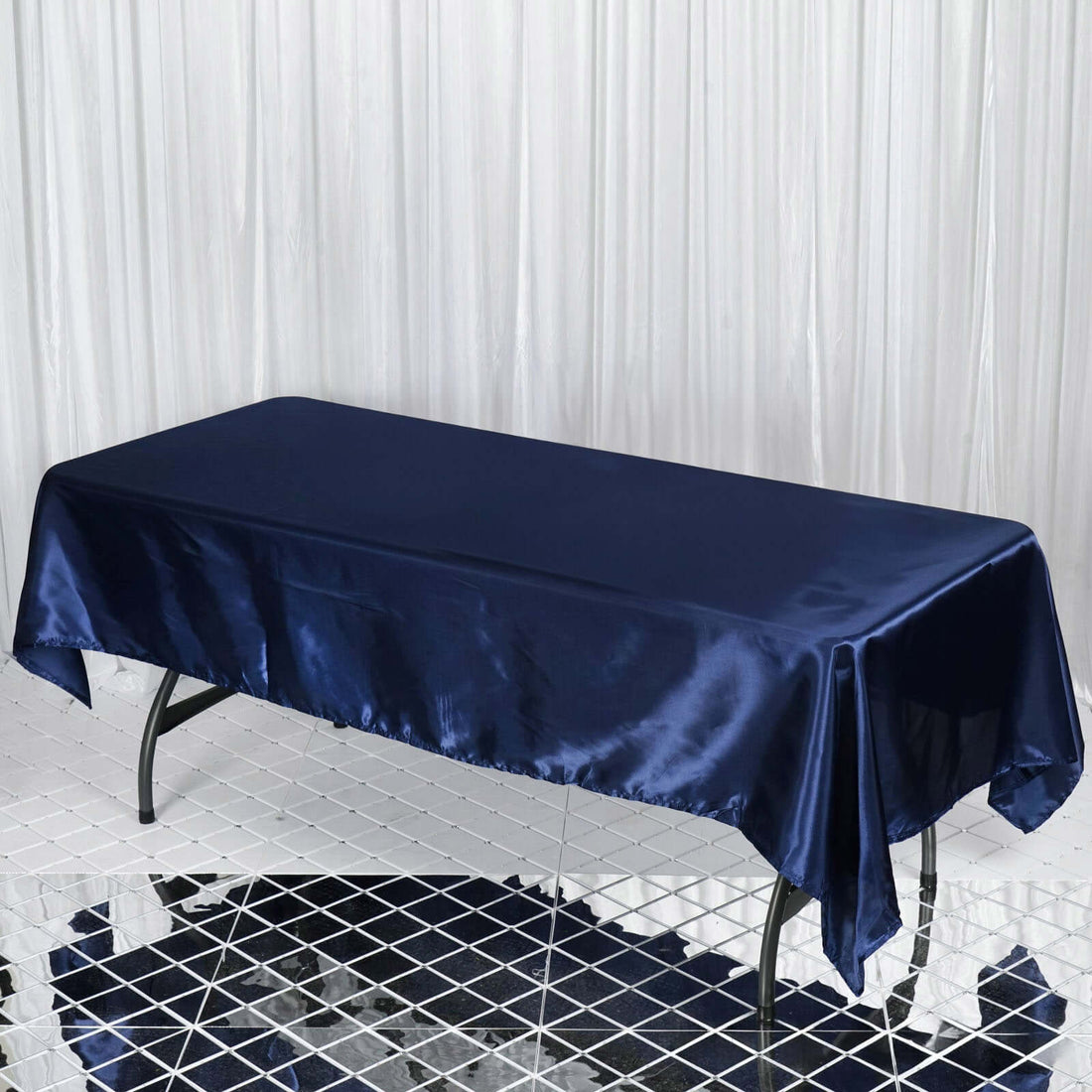 Navy satin tablecloth on a glossy surface