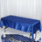Blue satin tablecloth draped over a table on a reflective surface.
