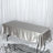 Silver satin tablecloth draped over a table in a studio setting.