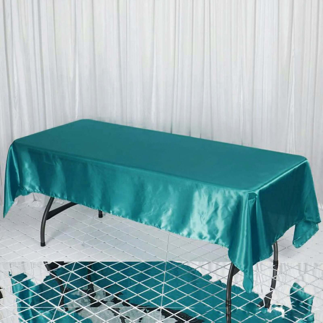 Teal satin tablecloth draped over a rectangular table