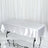 Shiny white tablecloth draped over a rectangular table