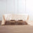 Beige tablecloth draped over a wooden table in a minimalist setting.