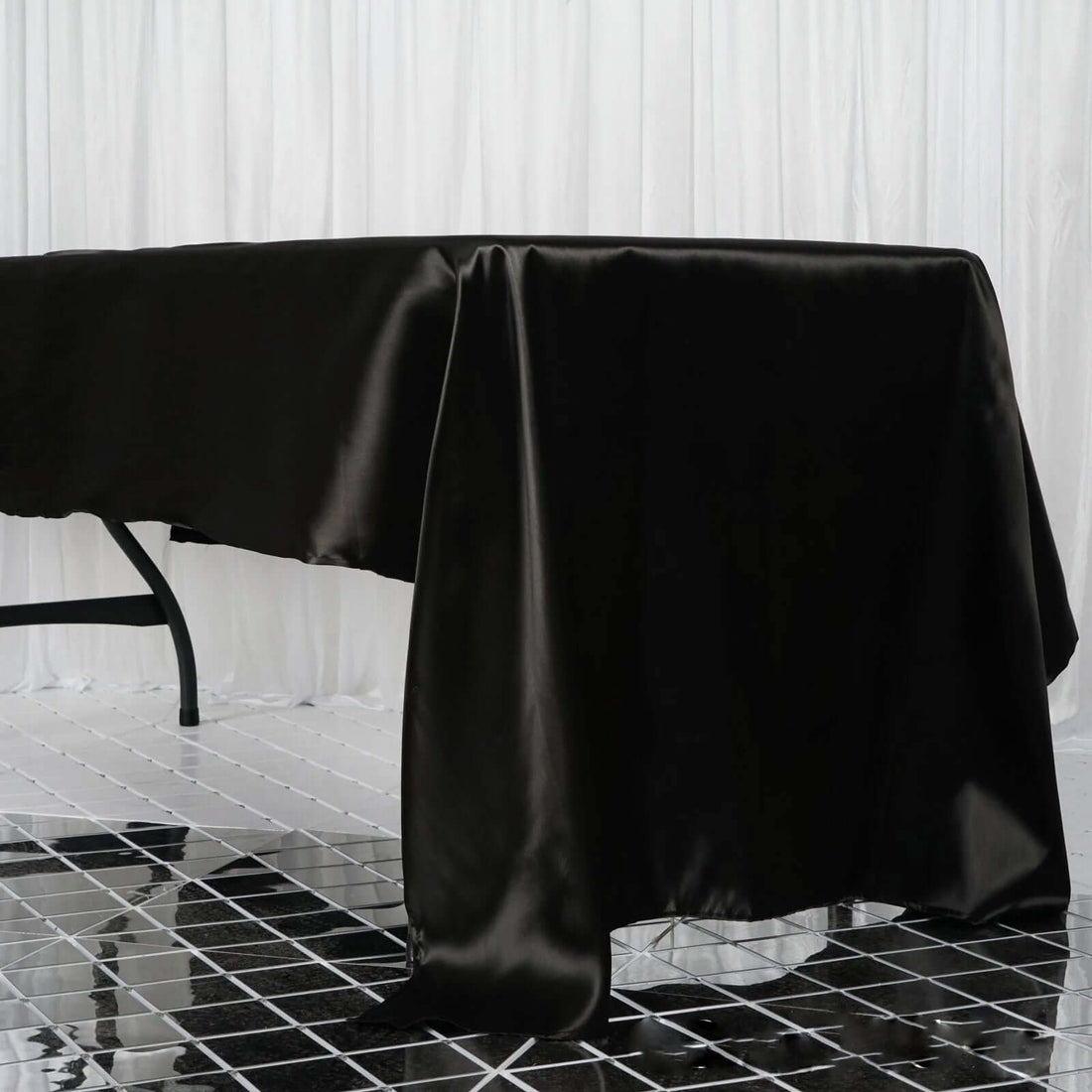 Black satin tablecloth draped elegantly over a table.