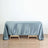 Blue satin tablecloth draped over a wooden table.