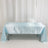 Light blue satin tablecloth on a table, elegantly draped.