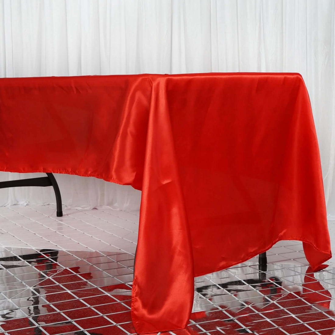 Red satin tablecloth draped elegantly over a table.