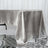 Silver satin tablecloth draped elegantly on a table.